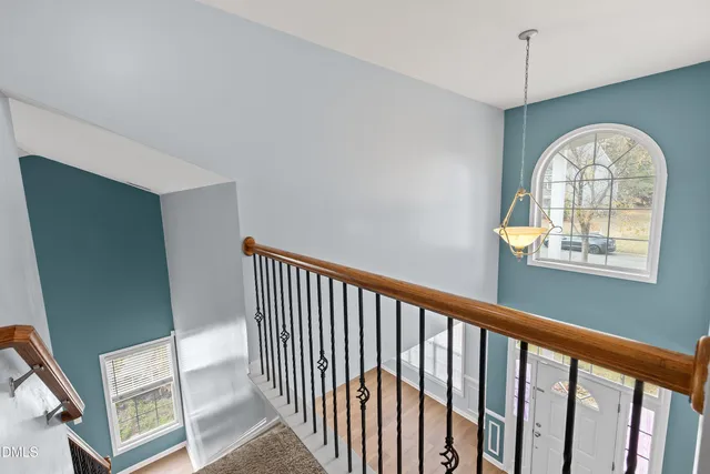 a view of a hallway to a livingroom with furniture