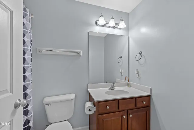 a bathroom with a sink toilet and a mirror