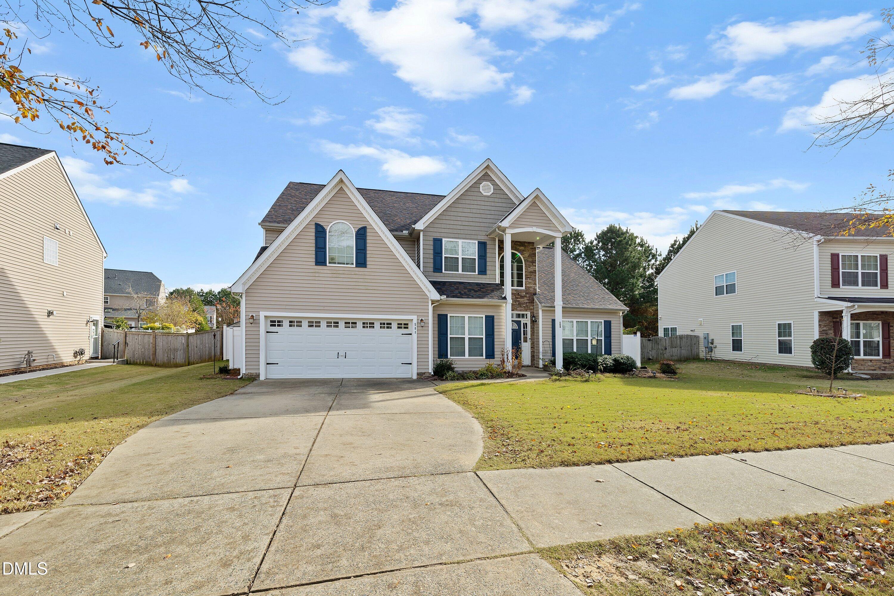 508 Arbor Crest Road Holly Springs, NC 27540 - Photo 3 of 45 a view of a big house with a big yard and large trees