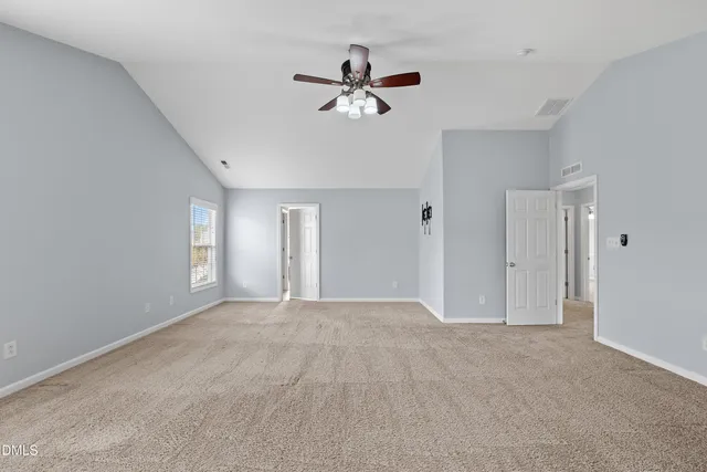 a view of empty room with ceiling fan