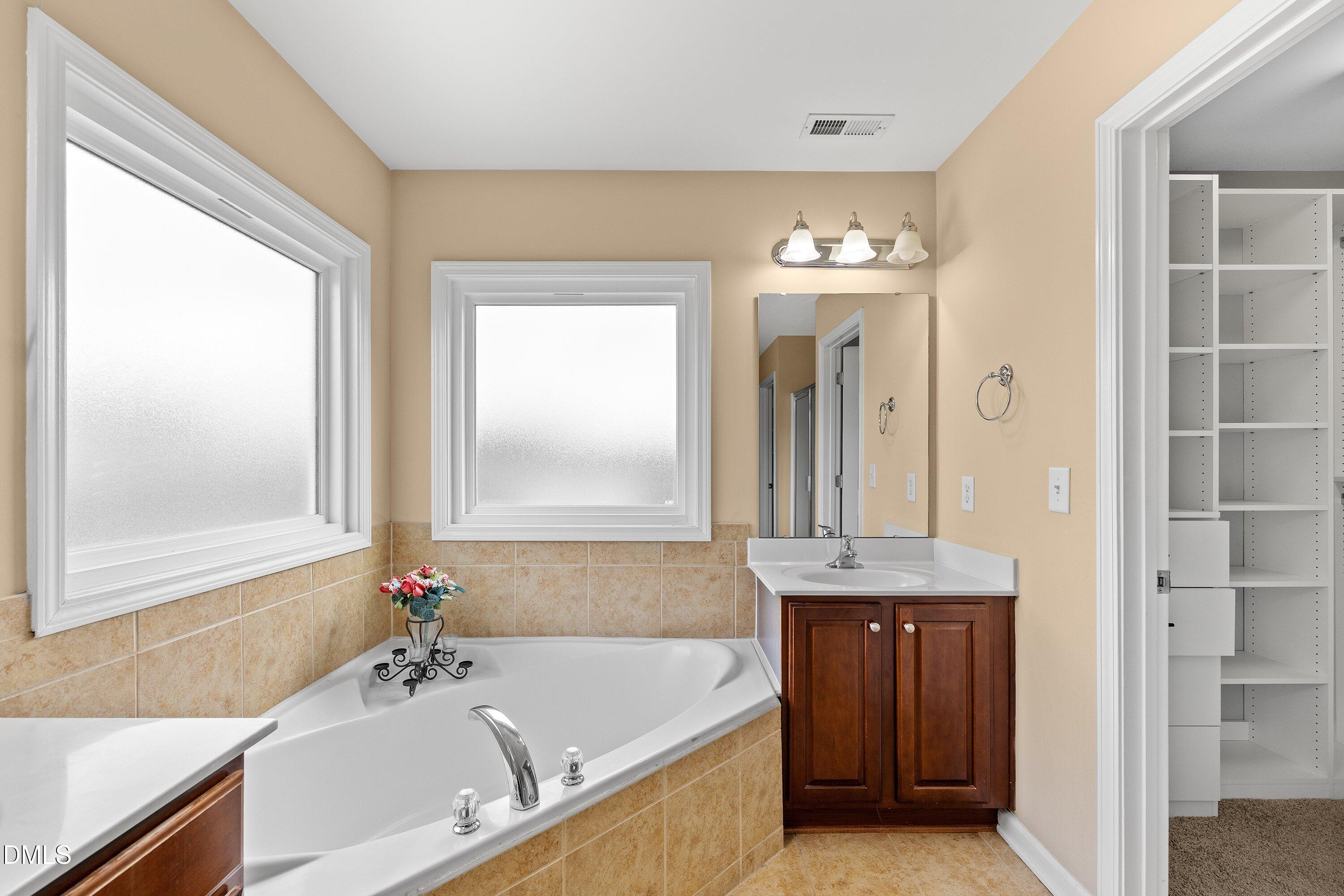 508 Arbor Crest Road Holly Springs, NC 27540 - Photo 36 of 45 a bathroom with a granite countertop sink and a mirror