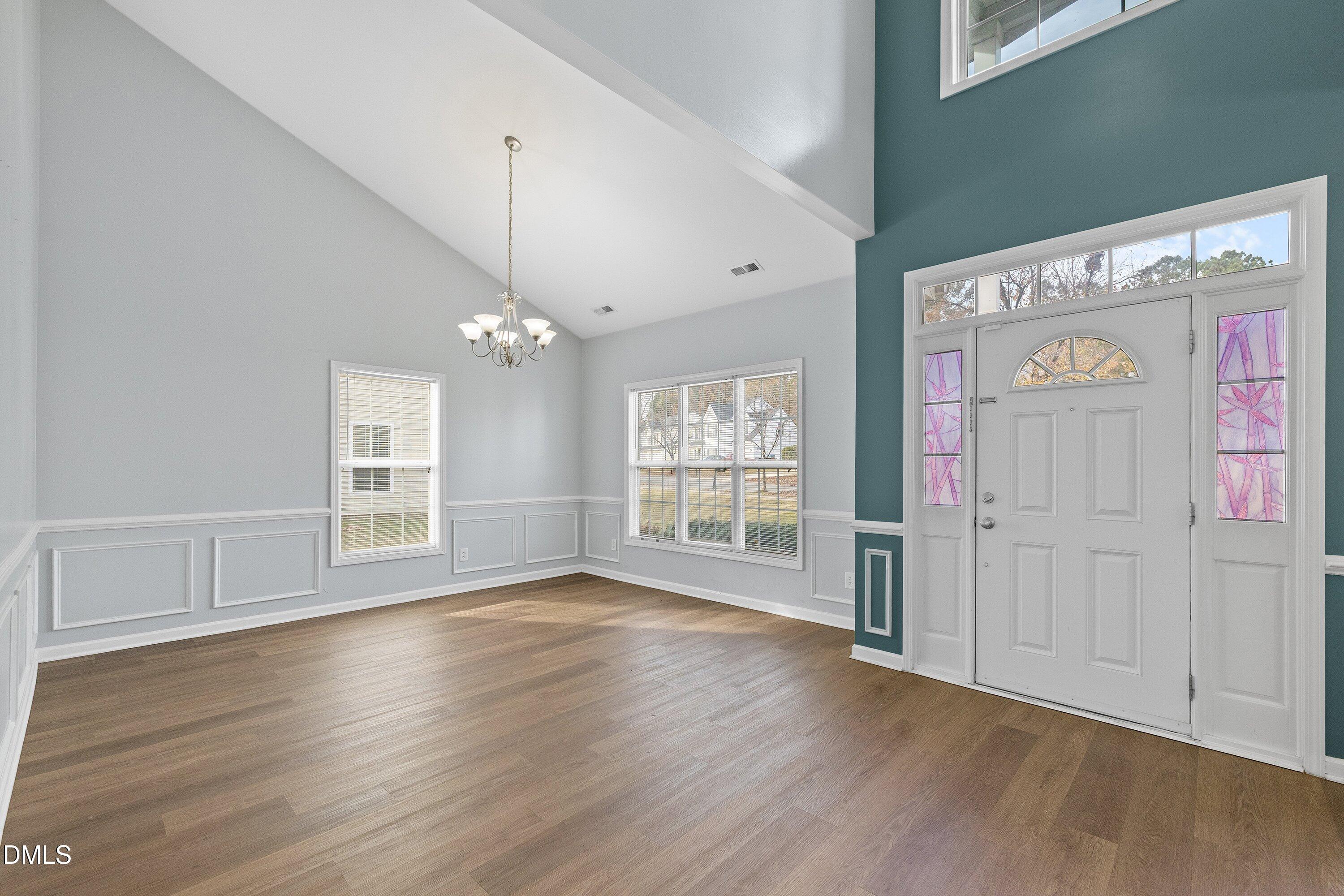 508 Arbor Crest Road Holly Springs, NC 27540 - Photo 6 of 45 a view of an empty room with wooden floor and a window