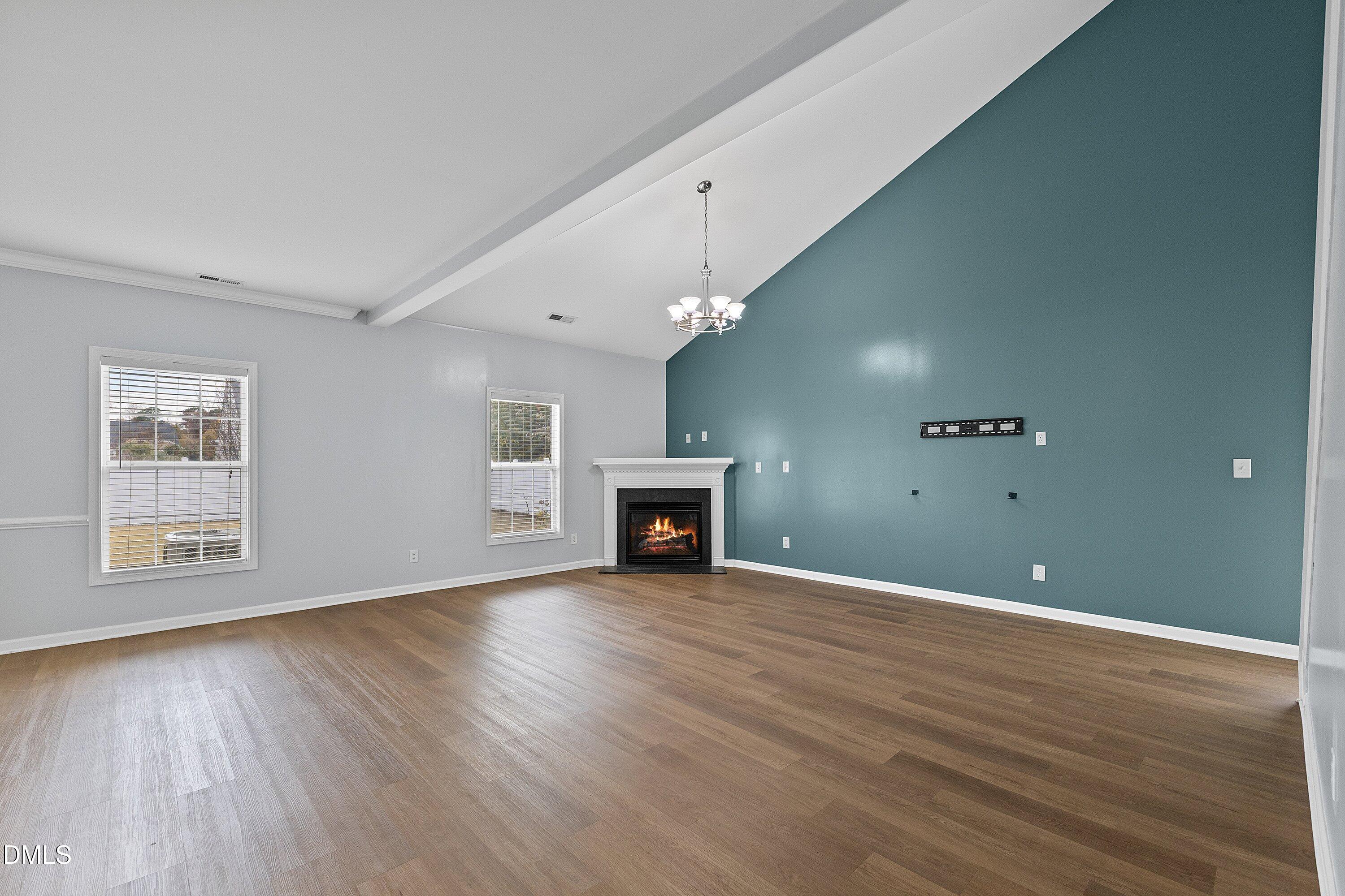 508 Arbor Crest Road Holly Springs, NC 27540 - Photo 9 of 45 a view of a livingroom with wooden floor fireplace and window