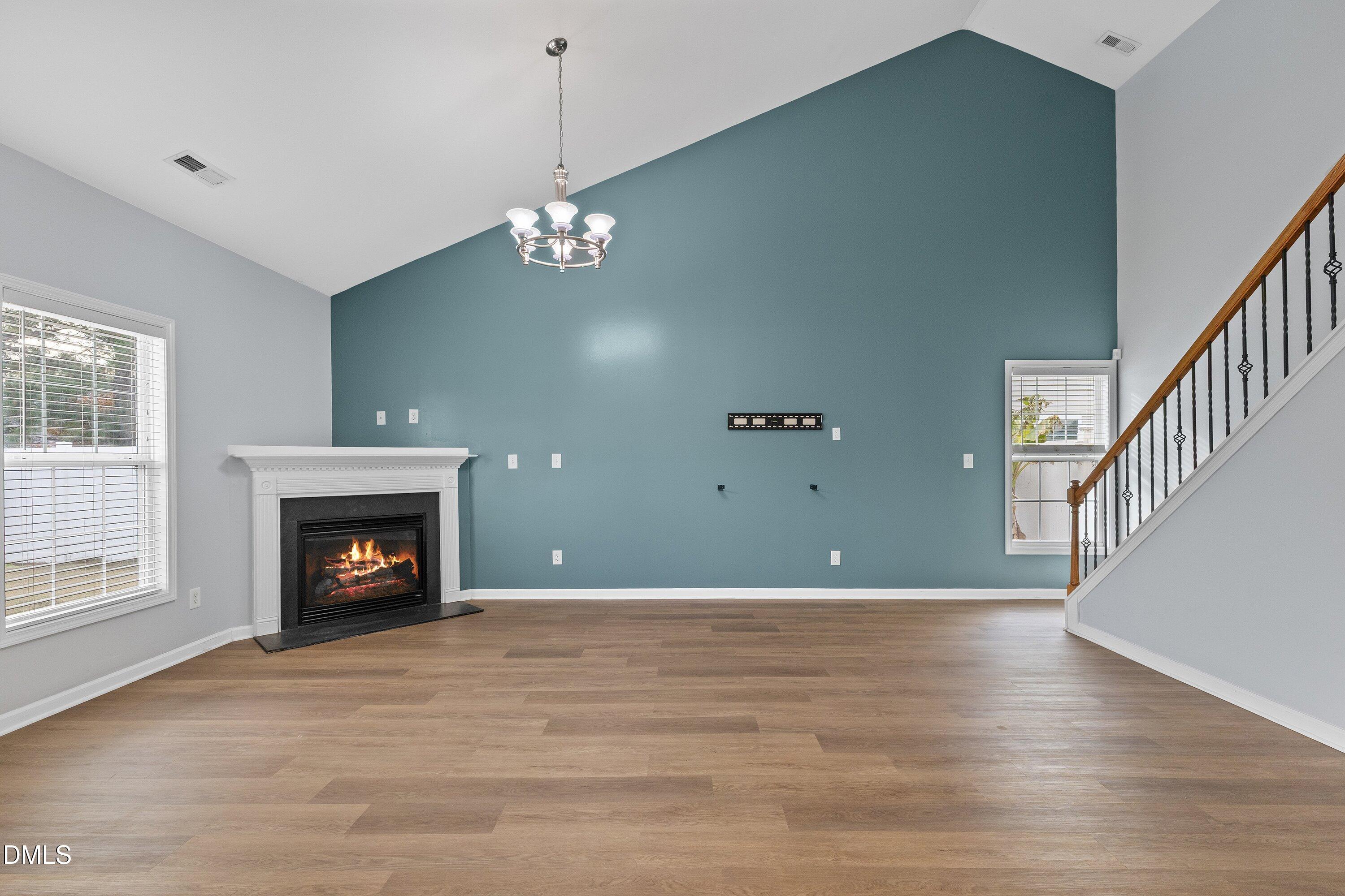 508 Arbor Crest Road Holly Springs, NC 27540 - Photo 10 of 45 a view of an empty room with wooden floor fireplace and a window