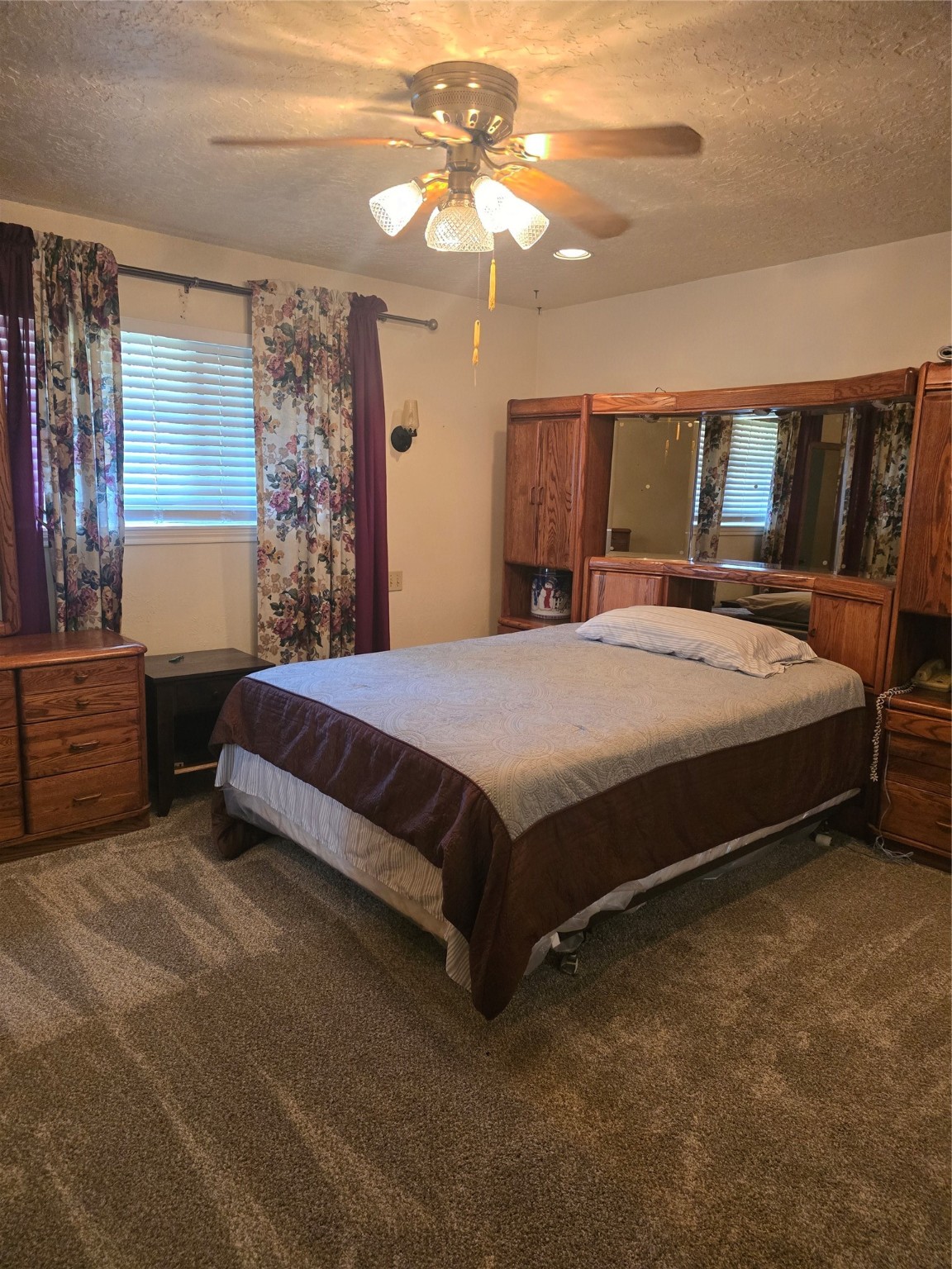 11831 Lone Shadow Trail Houston, TX 77050 - Photo 9 of 9 a bedroom with a bed dresser and a chandelier