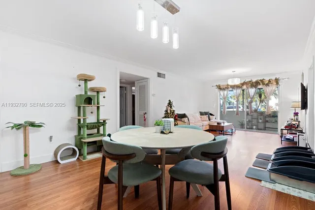 a view of a dining room with furniture and wooden floor