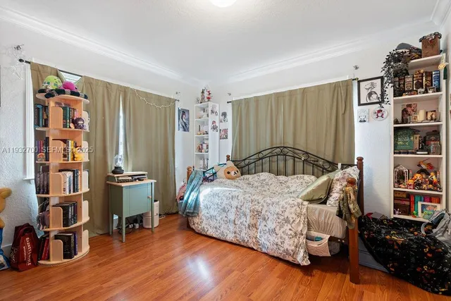 a bedroom with a bed furniture and a book shelf