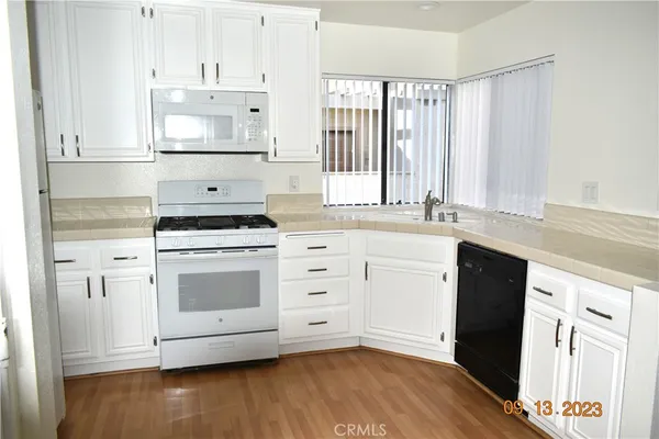 a kitchen with stainless steel appliances a stove a sink and a refrigerator
