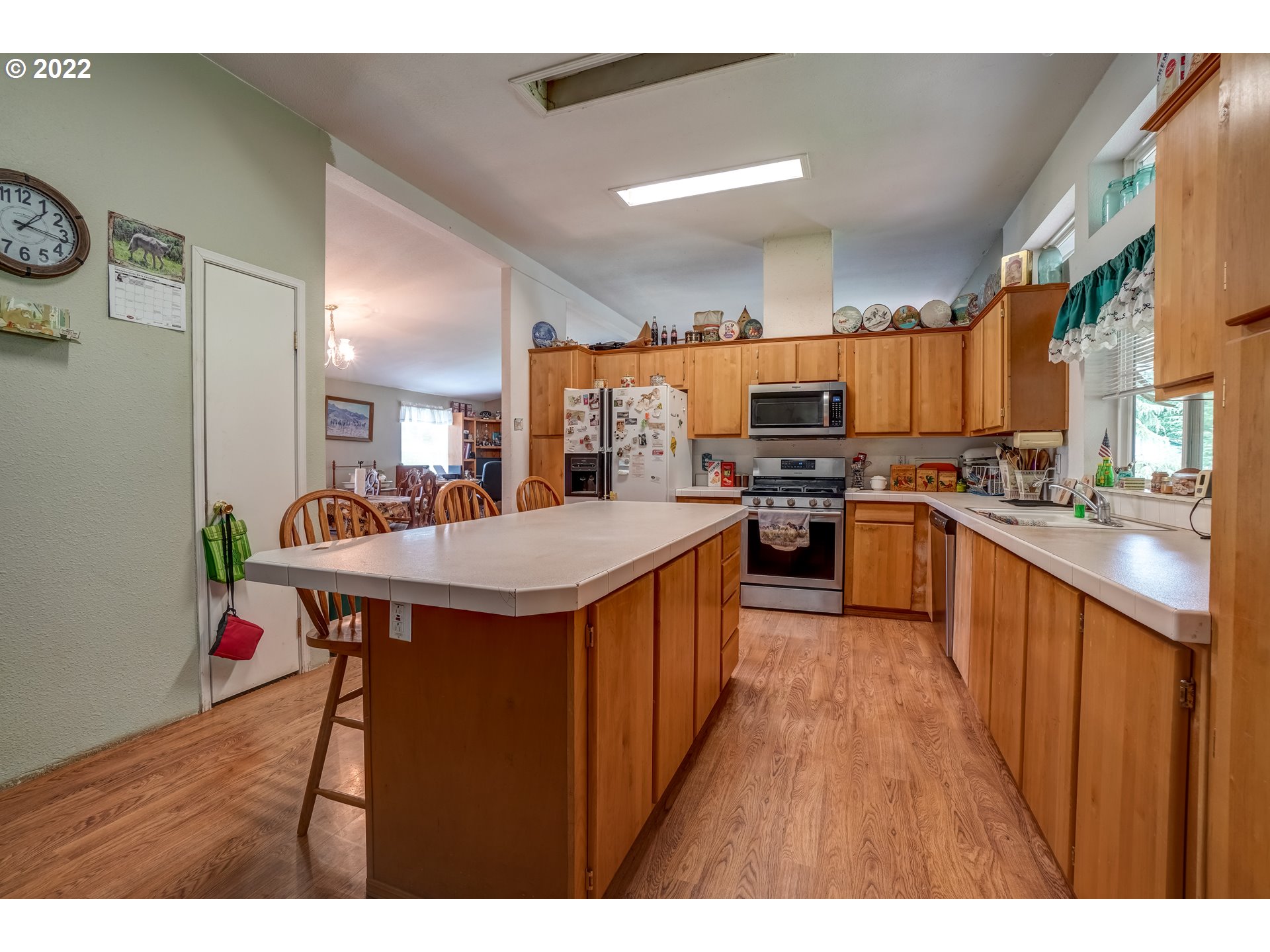 19887 South Ridge Road Oregon City, OR 97045 - Photo 12 of 26 a kitchen with stainless steel appliances a sink a stove top oven a counter space and cabinets
