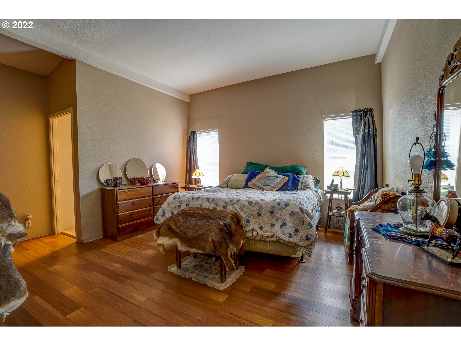 19887 South Ridge Road Oregon City, OR 97045 - Photo 16 of 26 a bedroom with a bed and wooden floor
