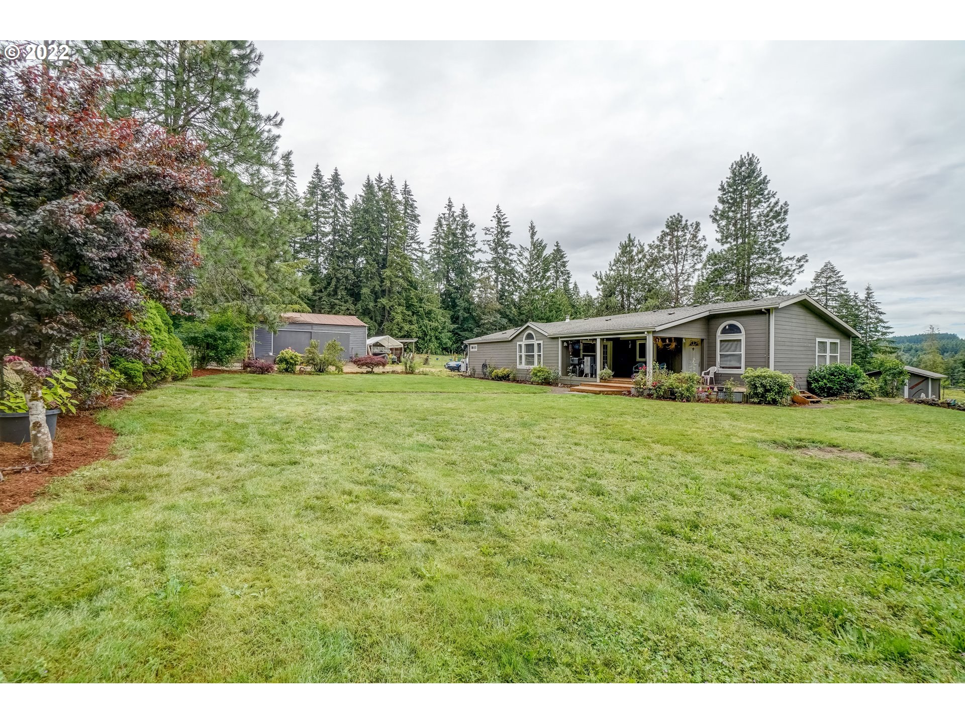 19887 South Ridge Road Oregon City, OR 97045 - Photo 4 of 26 a white house with a big yard and large trees