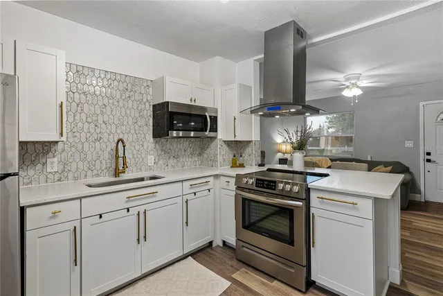 a kitchen with appliances a sink and cabinets