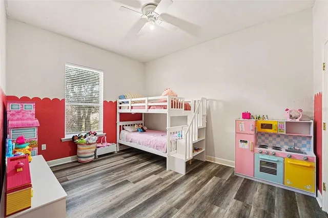 a bed room with a bed and a wooden floor