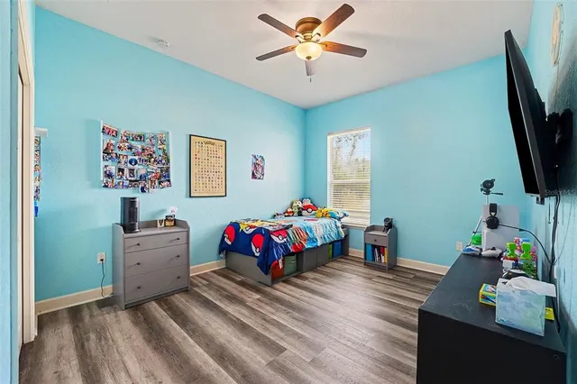 a bedroom with furniture and a flat screen tv