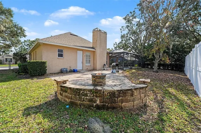 a view of a house with pool and sitting area