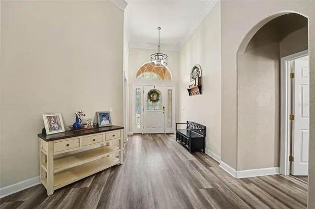 a view of a hallway with closet and wooden floor