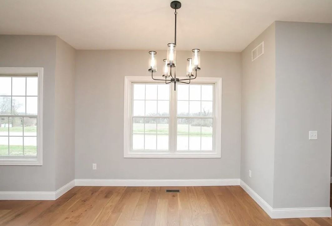 1 Saint Ivans Circle Bloomington, IL 61705 - Photo 11 of 29 a view of a room with wooden floor chandelier and windows