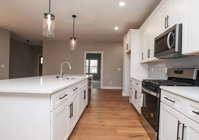 a kitchen with a stove top oven and sink