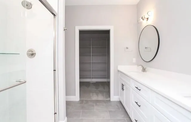 a bathroom with a double vanity sink mirror and shower