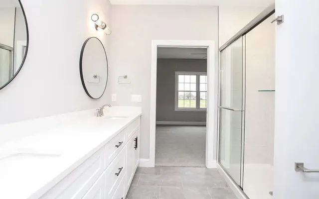 a bathroom with a sink a vanity and a mirror