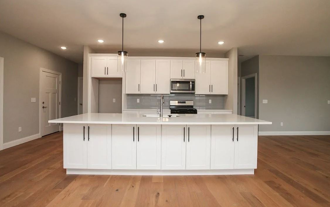 1 Saint Ivans Circle Bloomington, IL 61705 - Photo 9 of 29 a kitchen with stainless steel appliances kitchen island granite countertop a sink a microwave a refrigerator and white cabinets