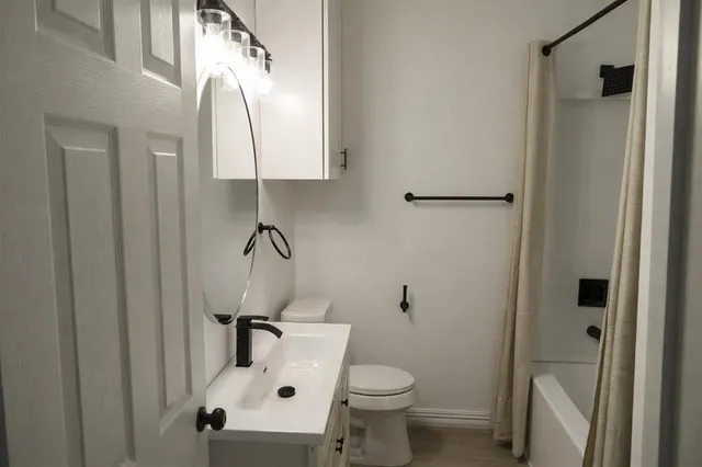 a bathroom with a toilet sink and shower