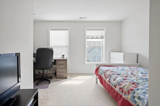 a bedroom with a bed and a chair