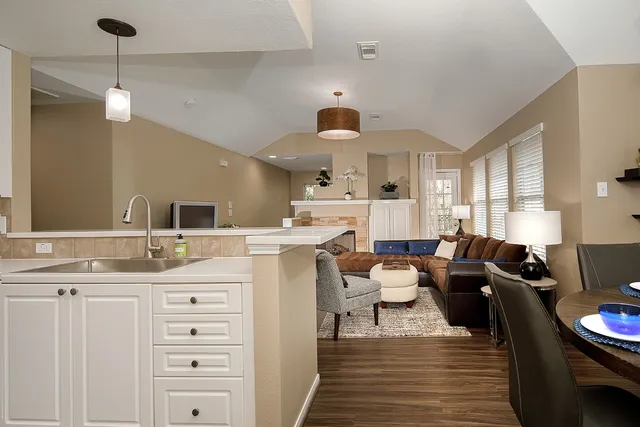 a living room with furniture and wooden floor