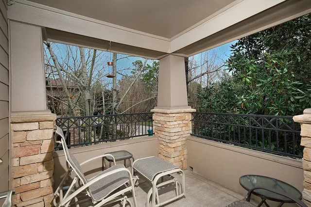 a bedroom with a bed a dresser and wooden floor