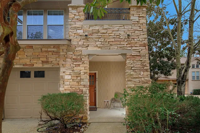 a brick building with a bench and potted plants
