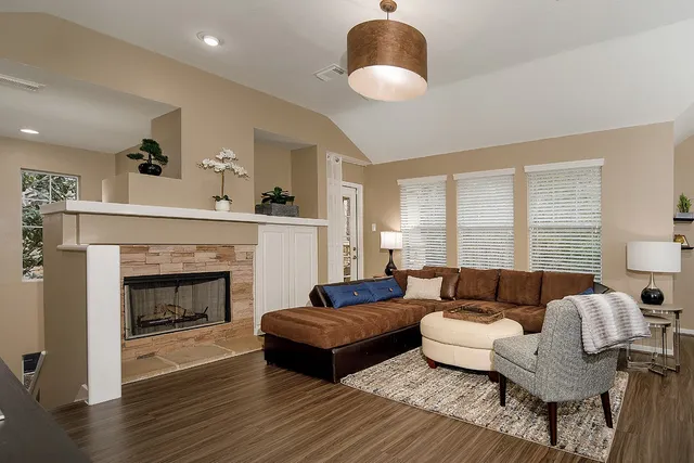 a living room with furniture and a fireplace