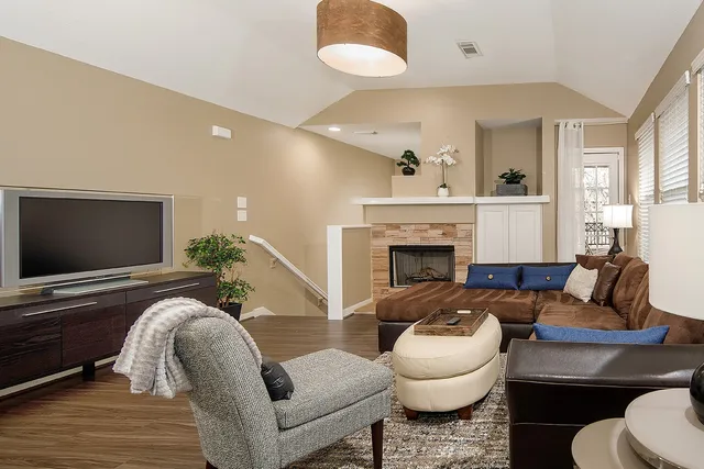 a living room with furniture and a fireplace