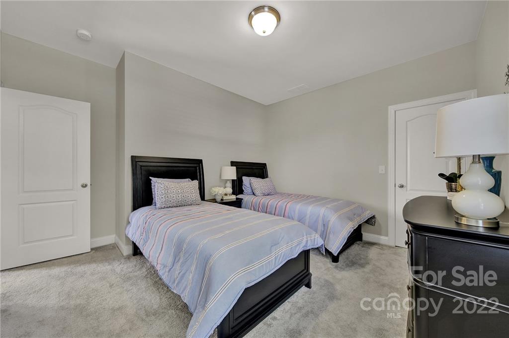 207 Kingsdown Avenue Charlotte, NC 28270 - Photo 20 of 48 a bedroom with two beds and a potted plant on a dresser