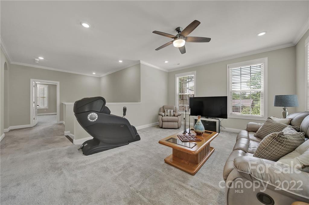 207 Kingsdown Avenue Charlotte, NC 28270 - Photo 21 of 48 a living room with furniture and a flat screen tv