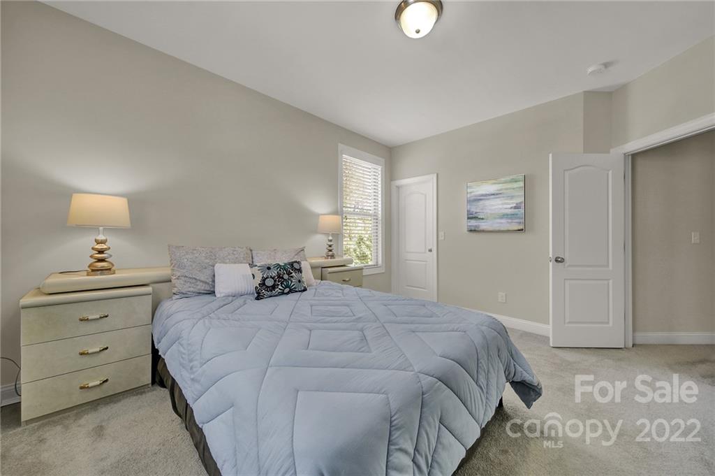 207 Kingsdown Avenue Charlotte, NC 28270 - Photo 26 of 48 a bedroom with a bed and a night stand