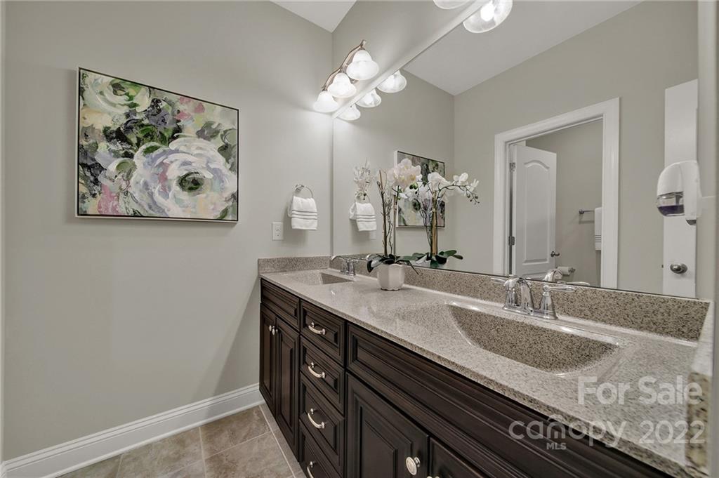 207 Kingsdown Avenue Charlotte, NC 28270 - Photo 28 of 48 a bathroom with a granite countertop sink a large mirror and vanity