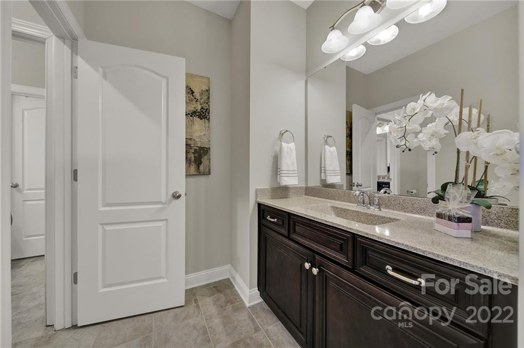 207 Kingsdown Avenue Charlotte, NC 28270 - Photo 34 of 48 a bathroom with a granite countertop sink a large mirror and a shower
