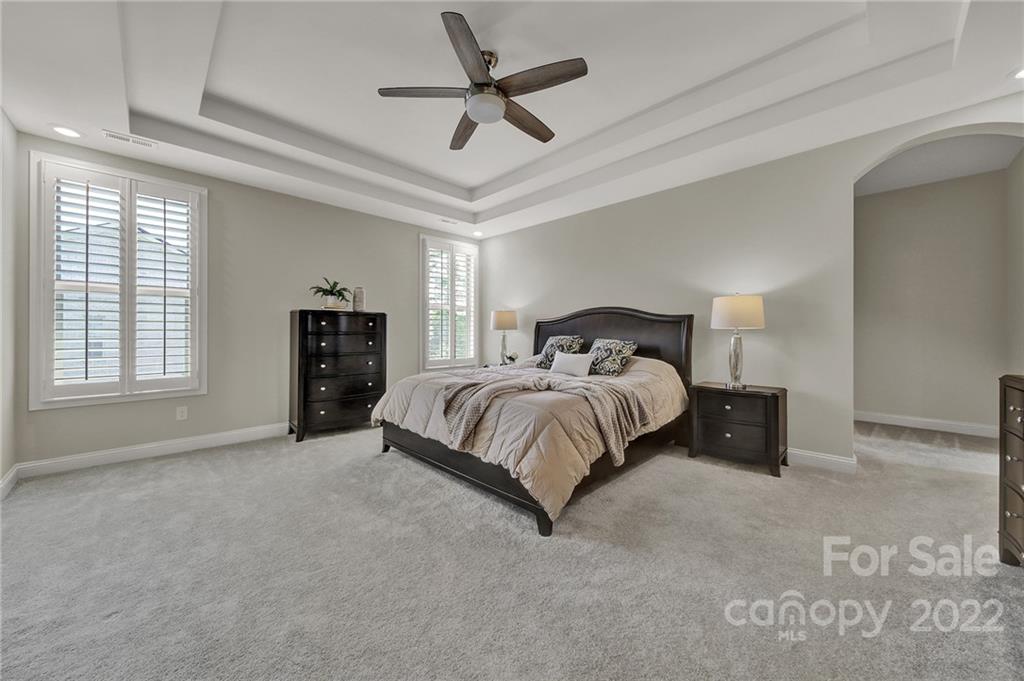 207 Kingsdown Avenue Charlotte, NC 28270 - Photo 36 of 48 a bedroom with a bed and a ceiling fan