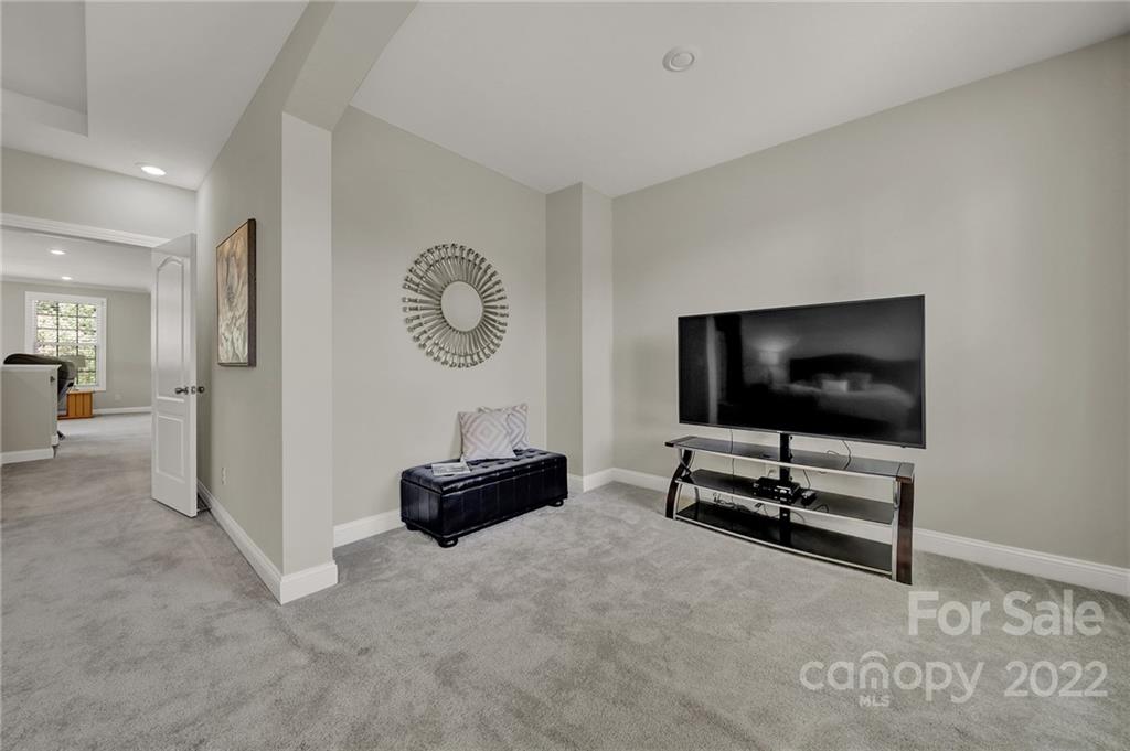 207 Kingsdown Avenue Charlotte, NC 28270 - Photo 39 of 48 a view of workspace with furniture and a flat screen tv