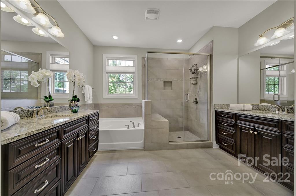 207 Kingsdown Avenue Charlotte, NC 28270 - Photo 40 of 48 a spacious bathroom with a granite countertop tub sink shower and mirror