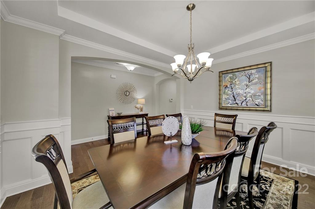 207 Kingsdown Avenue Charlotte, NC 28270 - Photo 4 of 48 a view of a dining room with furniture and chandelier