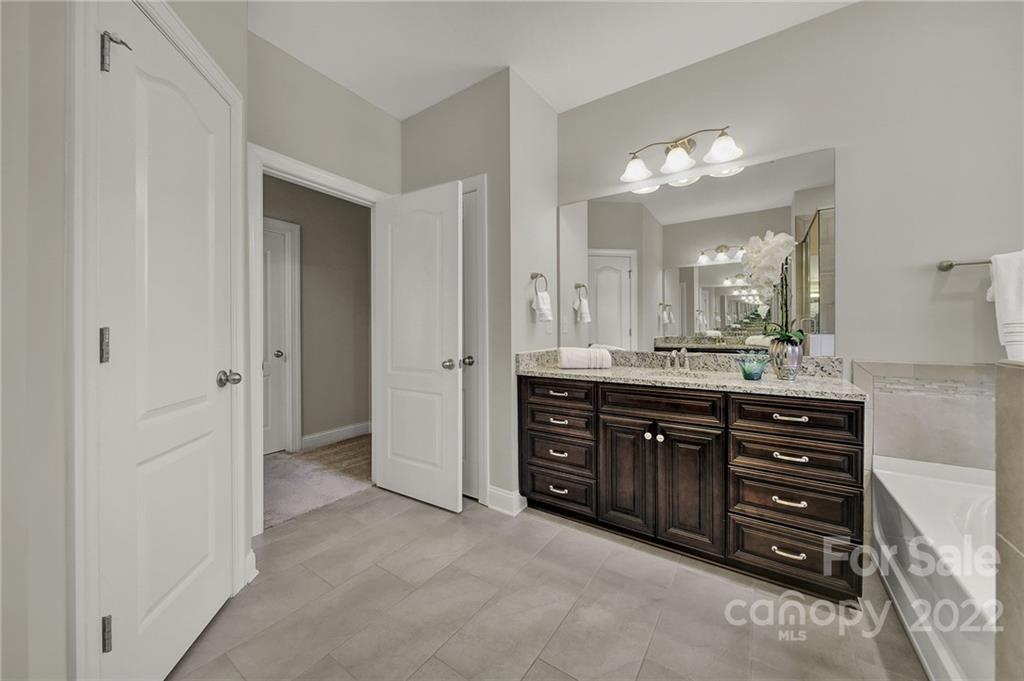 207 Kingsdown Avenue Charlotte, NC 28270 - Photo 41 of 48 a spacious bathroom with a double vanity sink and a mirror