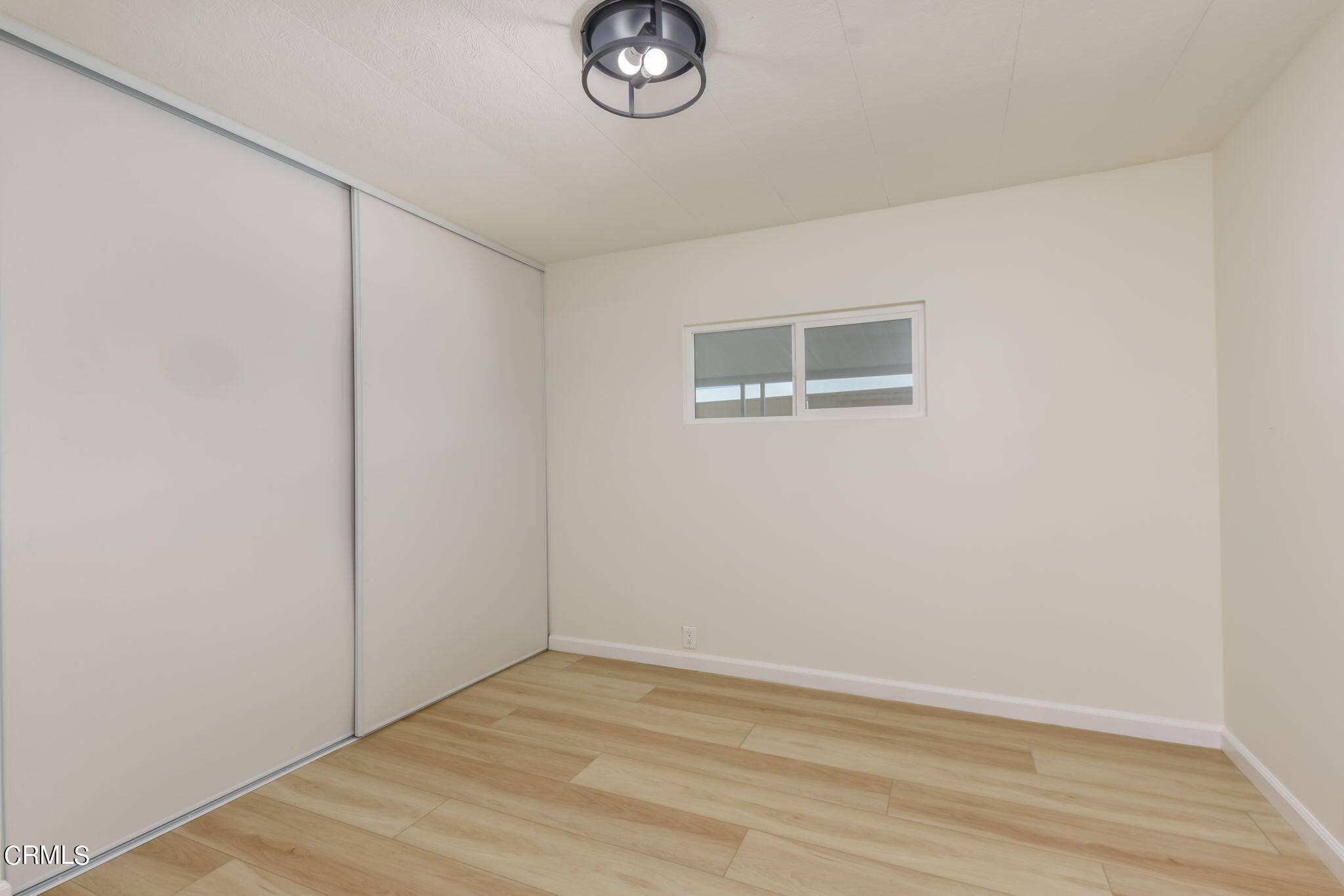 132 Rainbow Drive, Unit 158 Oxnard, CA 93033 - Photo 12 of 21 a view of empty room with wooden floor and fan