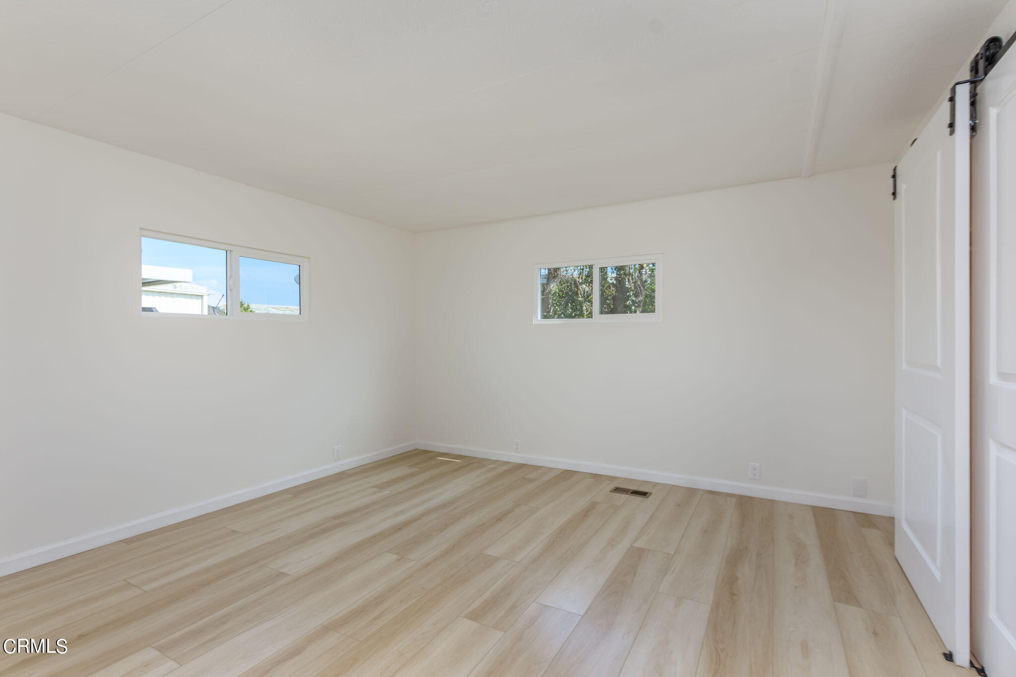 132 Rainbow Drive, Unit 158 Oxnard, CA 93033 - Photo 14 of 21 wooden floor in an empty room