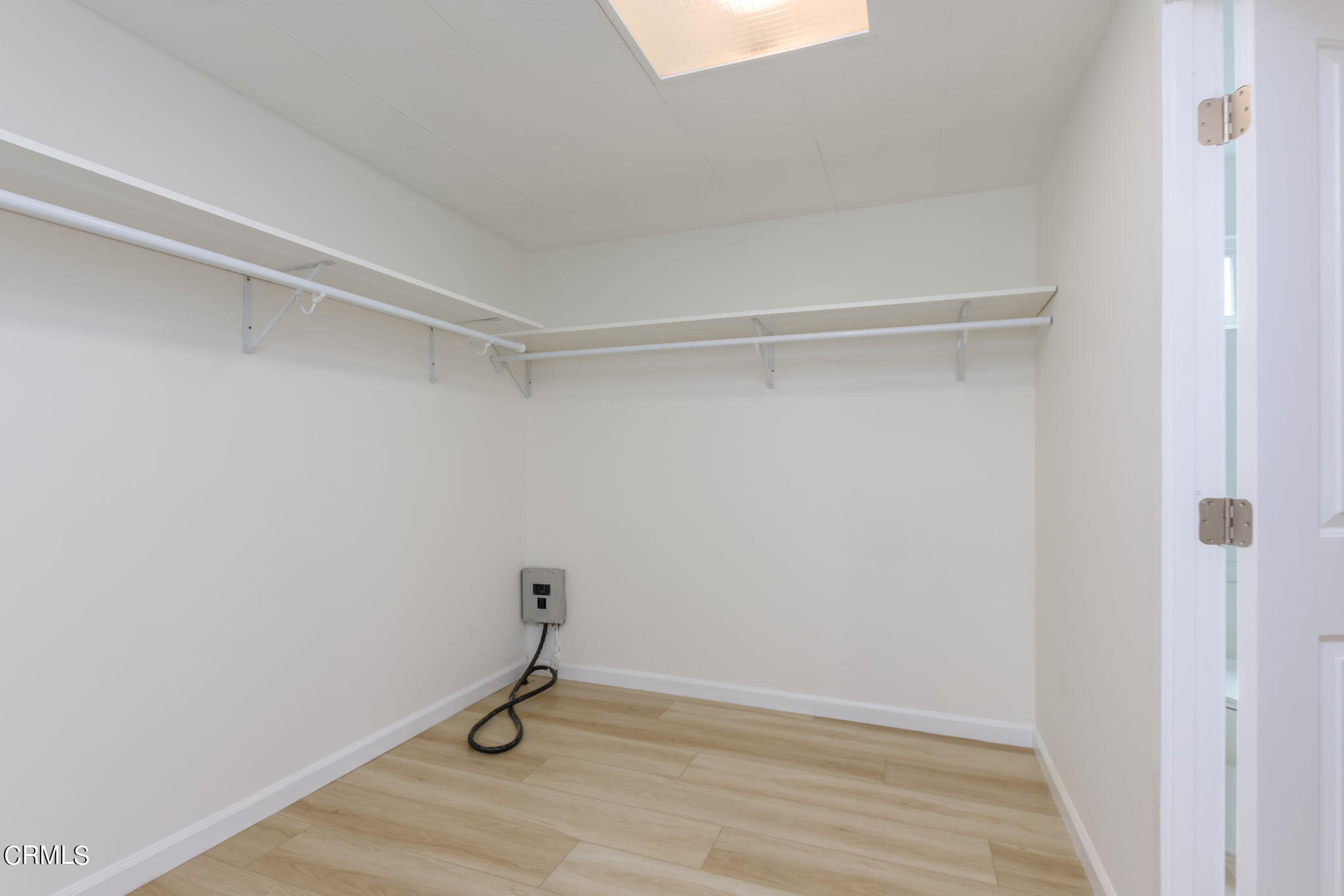 132 Rainbow Drive, Unit 158 Oxnard, CA 93033 - Photo 16 of 21 a room with a bench and a wooden floor