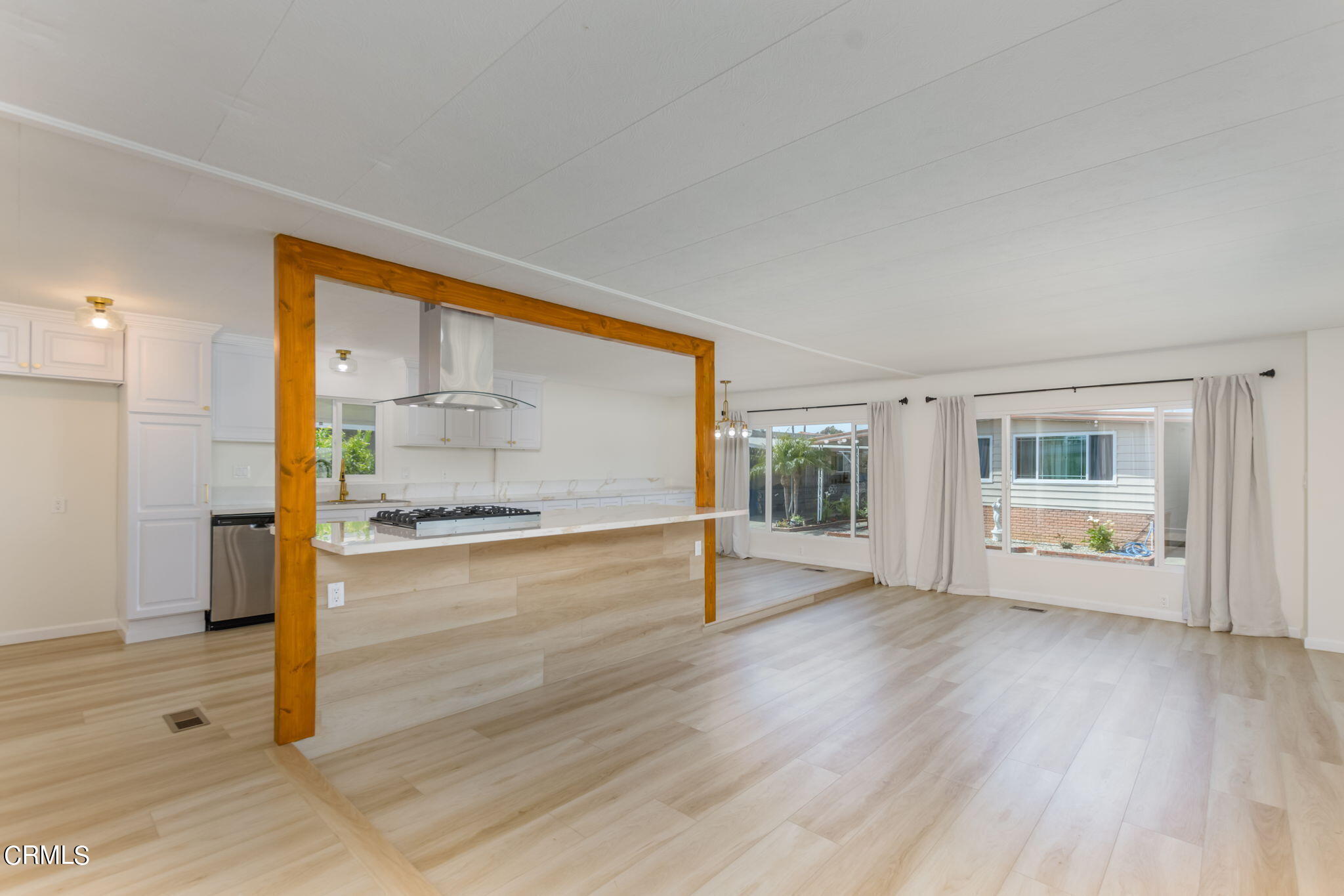 132 Rainbow Drive, Unit 158 Oxnard, CA 93033 - Photo 5 of 21 a view of an empty room with wooden floor and a window