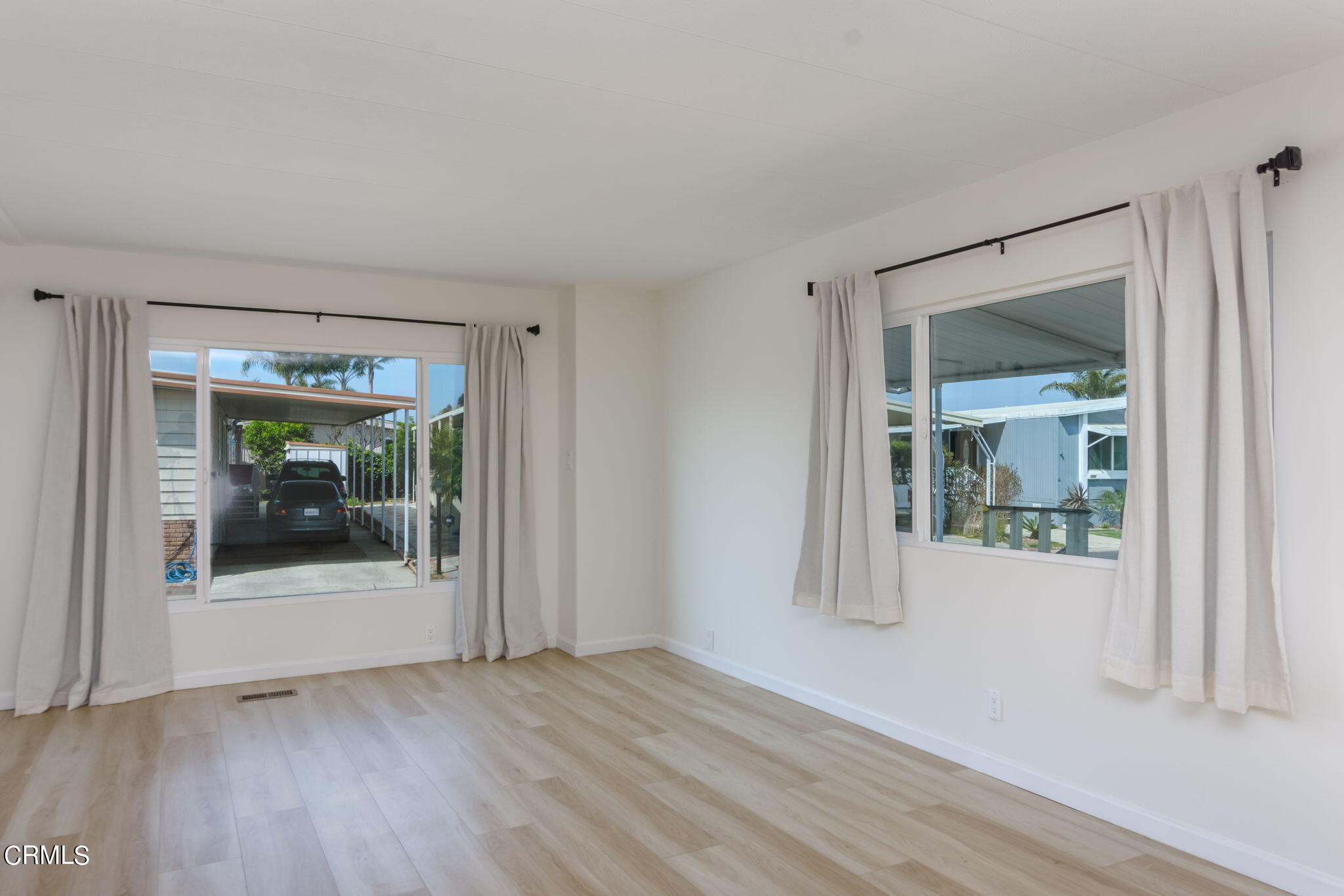 132 Rainbow Drive, Unit 158 Oxnard, CA 93033 - Photo 6 of 21 an empty room with wooden floor and a window