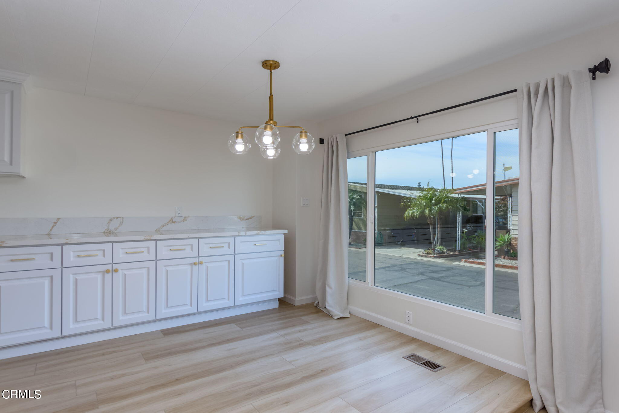 132 Rainbow Drive, Unit 158 Oxnard, CA 93033 - Photo 7 of 21 a view of a livingroom with a chandelier fan and wooden floor