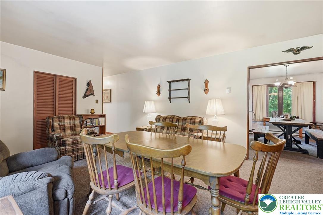 143 Logger Road Canadensis, PA 18325 - Photo 32 of 32 The open floorplan seamlessly connects the dining area to a spacious living room.