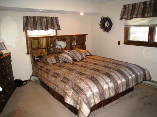 3579 South Bend Road Rockford, IL 61109 - Photo 6 of 10 a bed sitting in a bedroom next to a window